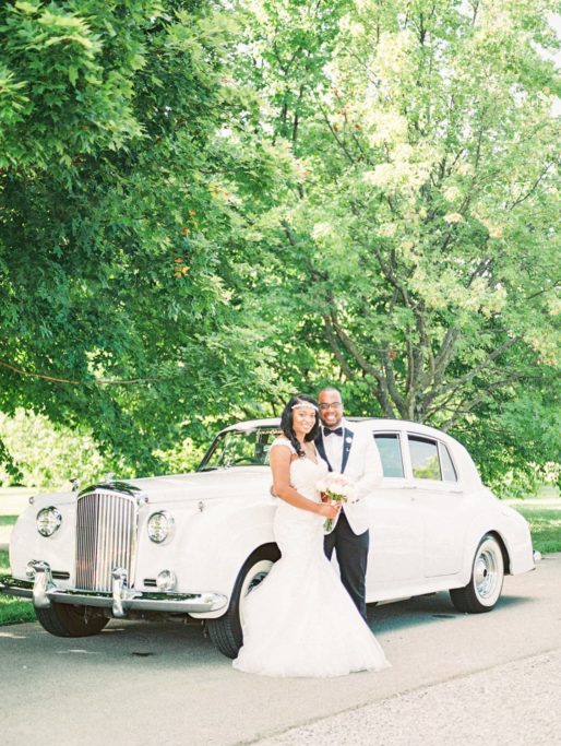 Black Couple in Front of a Vintage Bentley, vintage wedding car rental
