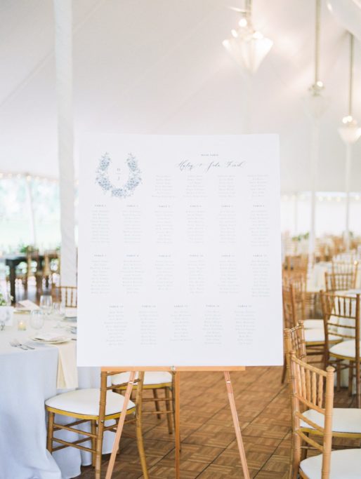 Wedding Seating Chart Sign on a Stand under a White Tent Wedding Reception at Zingerman Cornman Farms Wedding Venue