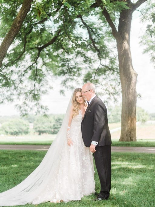 Bride in white, lace long sleeve Galia Lahav dress approaching her dad for a first look at a Zingermans Cornman Farms Wedding